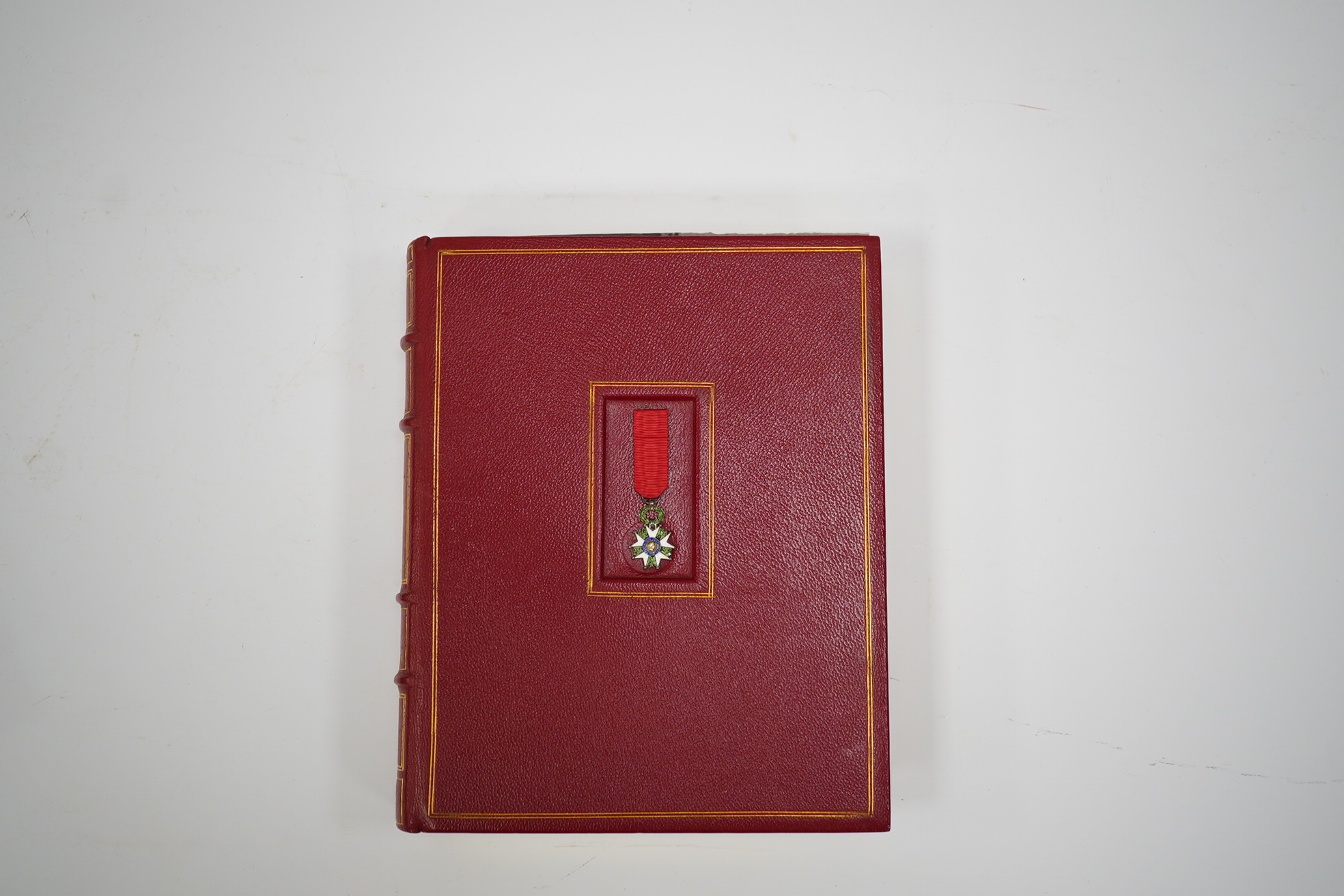 A framed medal group; Legion D'Honneur France, a British Cross, Italian order of Merit and Croix De Guerre with related book; La Legion d’Honneur by Jean Daniel, plus some related paperwork, three related medal miniature